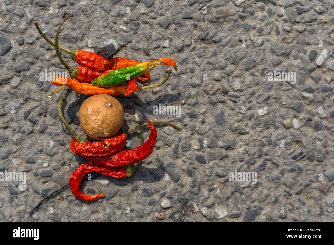 lemon chilli bundle on the street. An old practice of throwing lemon and chilli bundle as a part of taboo in INDIA to avoid bad luck. Stock Photo