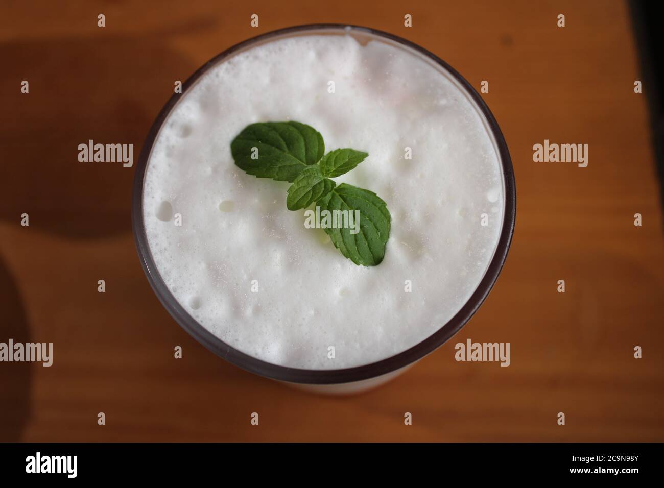 Top down view of mint leaf garnish on latte foam Stock Photo Alamy