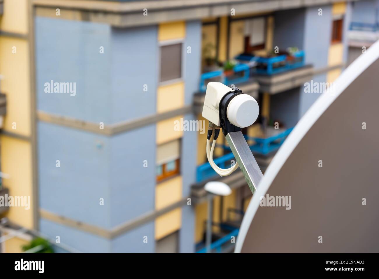 Close up of a satellite dish and LNB on a balcony Stock Photo
