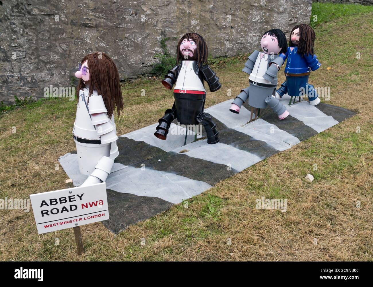 Settle, North Yorkshire, UK. August 1st 2020: The annual Flowerpot Festival opens in Settle, North Yorkshire, UK.  Topical flowerpot figures. designed and made by local residents, appear all around the Yorkshire market town during August. Shown are The Beatles walking over the Abbey Road zebra crossing, from the famous Abbey Road album cover. This particular display was made by local resident Richard Handscombe. Credit: John Bentley/Alamy Live News Stock Photo