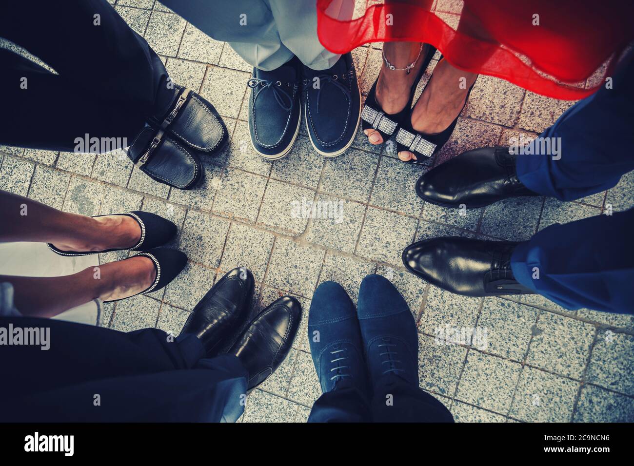 Top view of feet of fashionable, stylish people standing in a circle Stock Photo