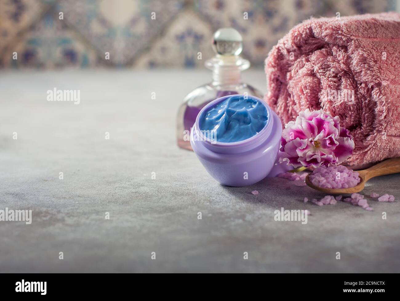 Spa. Natural cream, sea salt, flowers and a towel. Copy background space. Selective focus Stock Photo