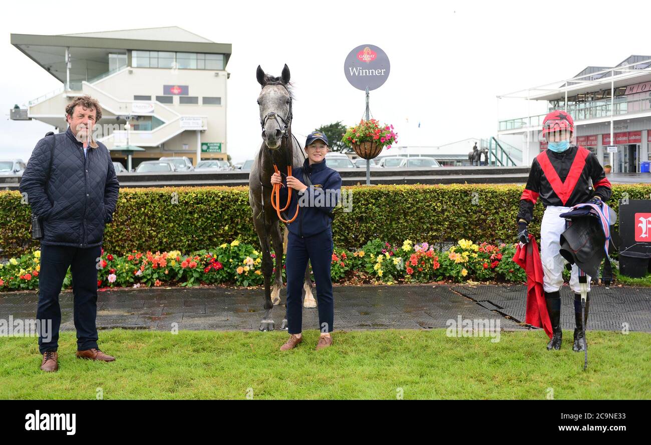 (From left to right) trainer Ado McGuinness, groom Zoe Boardman and jockey Gavin Ryan after Sirjack Thomas wins the O'Leary Insurances Handicap during day six of the 2020 Galway Races Summer Festival at Galway Racecourse. Stock Photo