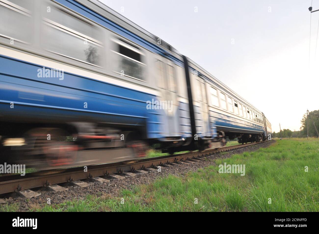 A high-speed diesel train moves quickly by rail. Blur Stock Photo