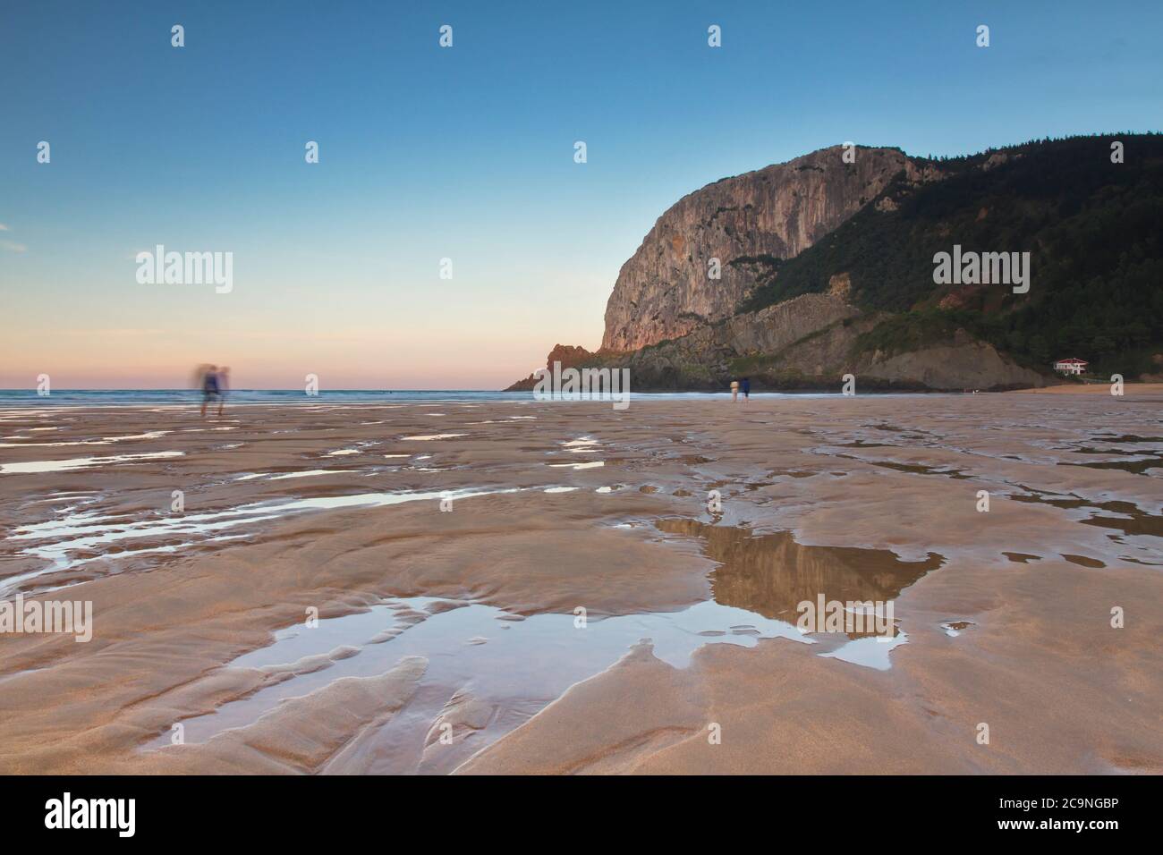 Ibarrangelu, Bizkaia/Basque Country; Sept. 26, 2015. People strolling at sunset on Laga beach at low tide. Stock Photo