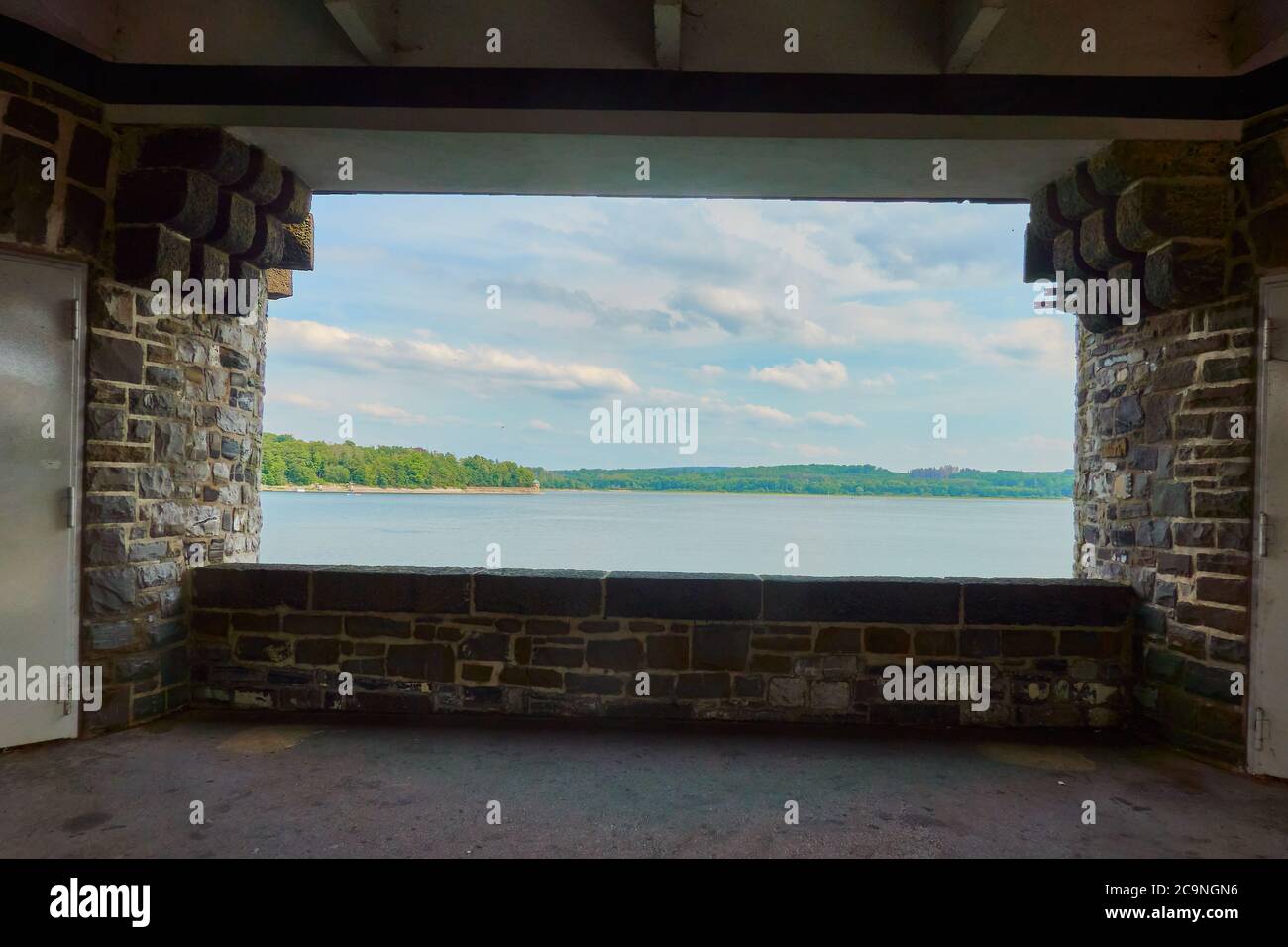 View through an opening in the dam wall to the Moehne dam, Germany Stock Photo