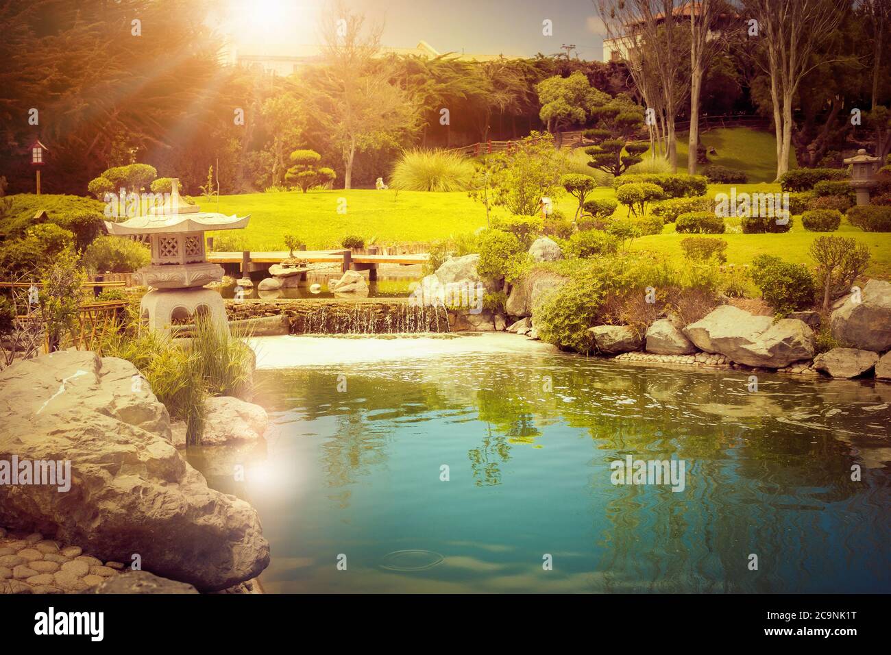 Japanese garden with beautiful stone lantern and reflections in the pond at sunset in La Serena, Chile Stock Photo