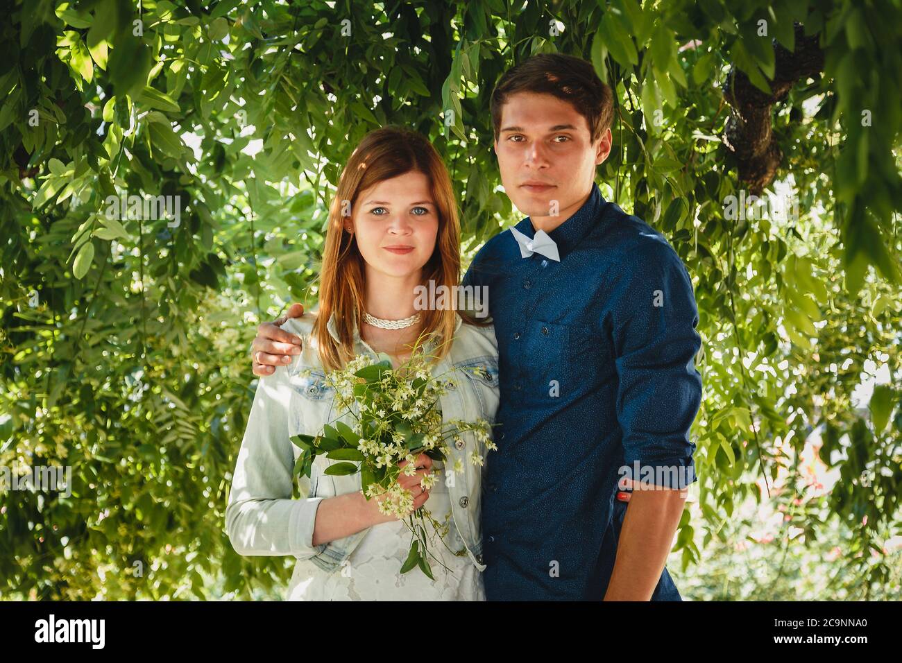 Happy stylish loving couple of hipsters hugging in a park Stock Photo