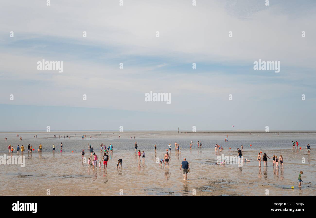 Norddeich, Germany. 01st Aug, 2020. Visitors are on the beach of Norddeich  during low tide in the mudflats at summer temperatures. Credit: Mohssen  Assanimoghaddam/dpa/Alamy Live News Stock Photo - Alamy