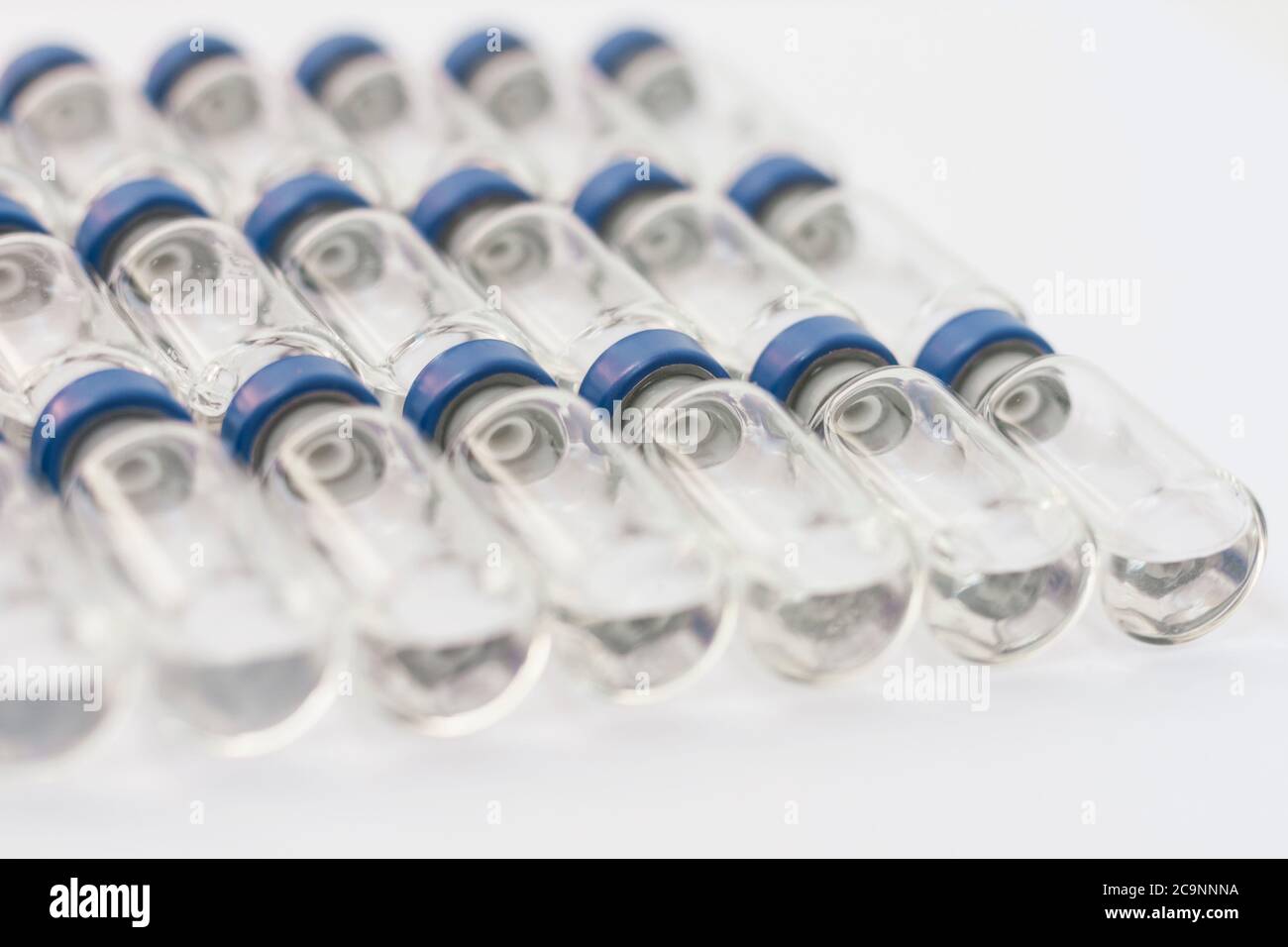 Glass medicine bottles with injection fluid with blue aluminium caps