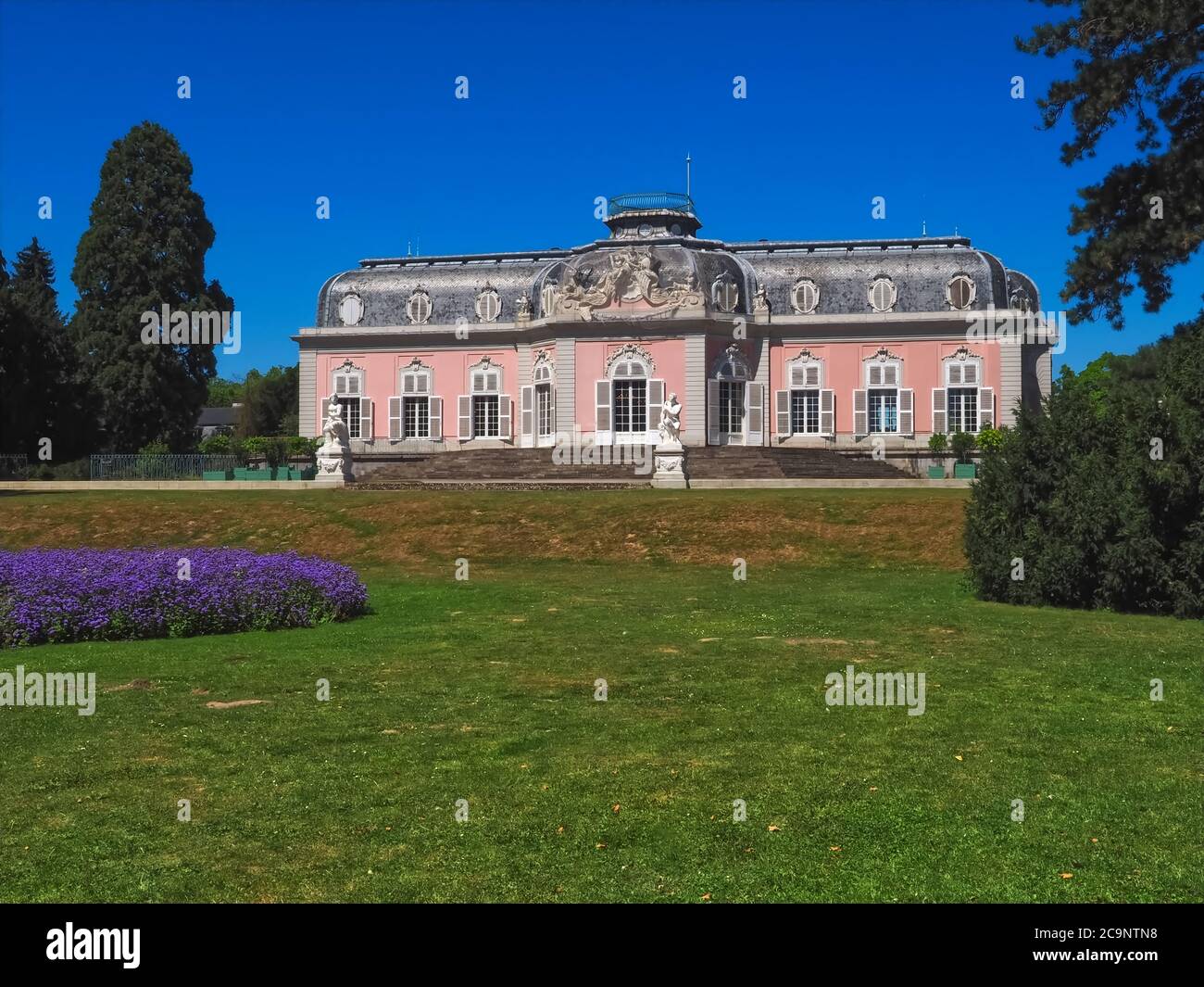 Romantic pink castle in Duesseldorf Schloss Benrath with a beautiful park and impressive sculptures Stock Photo