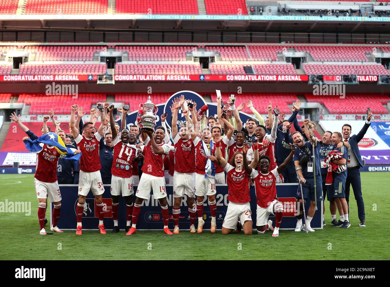Arsenal celebrate their victory with the FA Cup trophy after the Heads