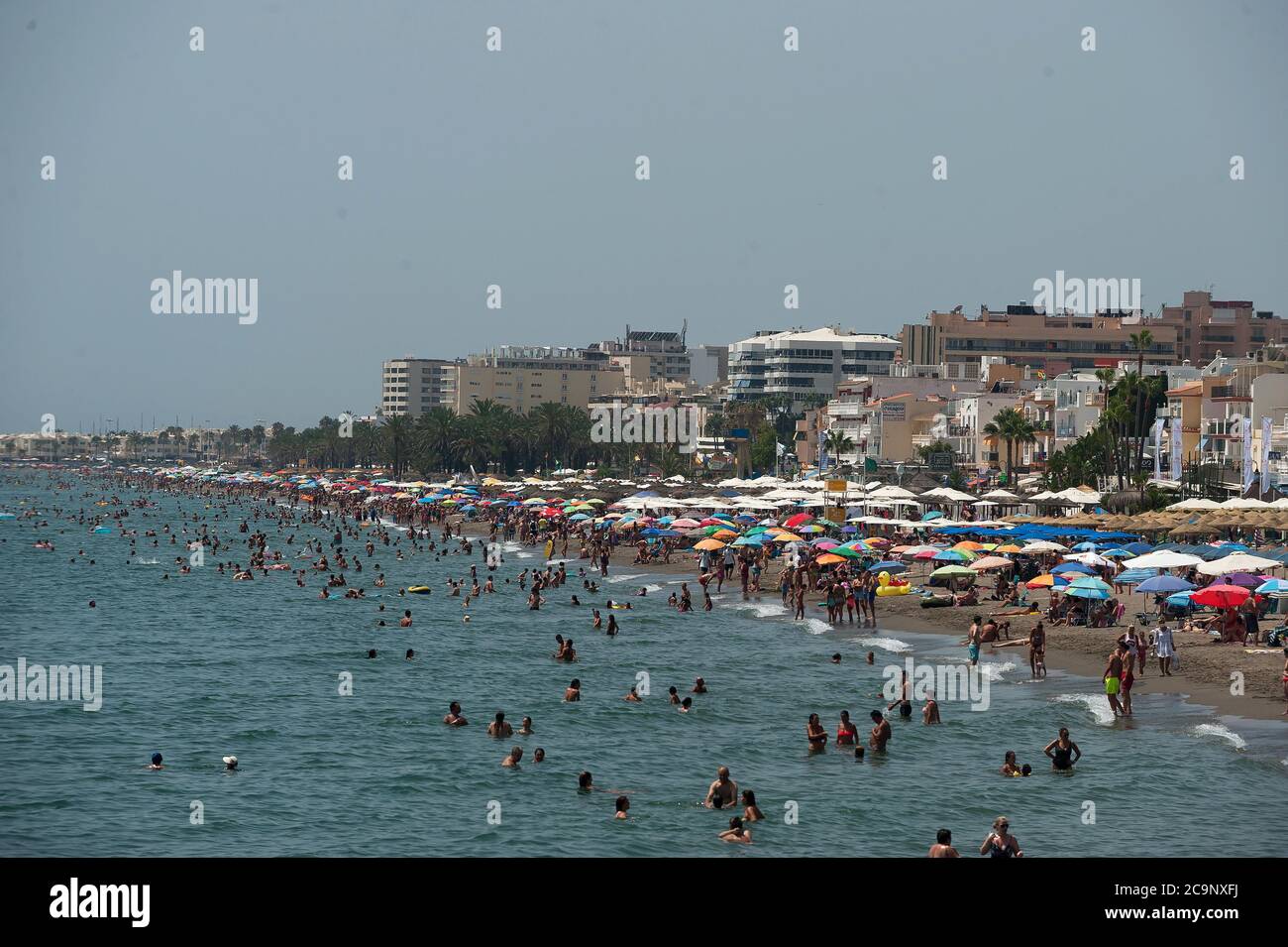 Malaga, Spain. 1st Aug, 2020. A general view of Rincon Sol beach of Torremolinos as people enjoy the good weather during a hot summer day.The first heavy heat wave hits the country with high temperatures. In Andalusia, according to the Spanish Meteorology Agency, majority of the cities are in orange warning with temperatures over 40 degrees Celsius during the weekend. Credit: Jesus Merida/SOPA Images/ZUMA Wire/Alamy Live News Stock Photo