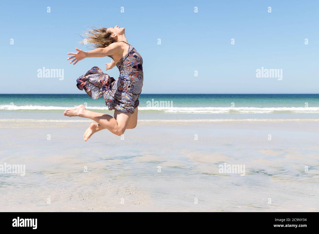 Mature woman enjoying herself on the beach Stock Photo - Alamy