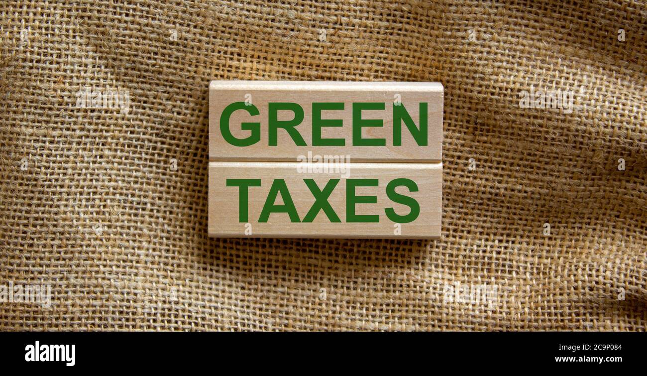 Wooden blocks form the text 'green taxes' on beautiful canvas background. Ecology concept. Stock Photo