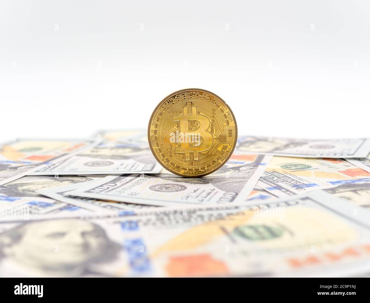 bitcoin concept coin on hundred dollars bills Stock Photo - Alamy