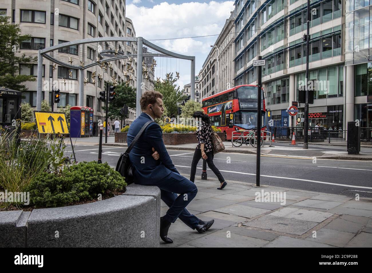 Middle aged man skateboards down Cheapside in the City of London financial district on a weekday afternoon, London, UK Stock Photo