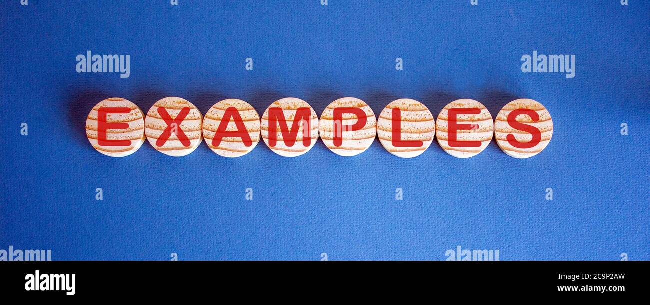 Wooden small circles with word examples on blue background. Concept ...