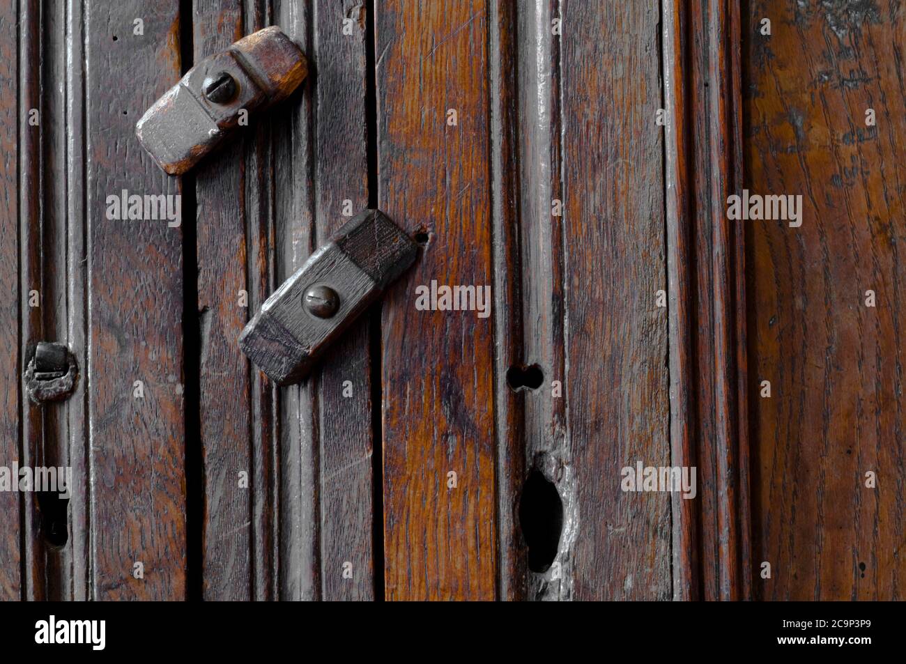 Fragment of an antique wooden cupboard with wooden locks Stock Photo