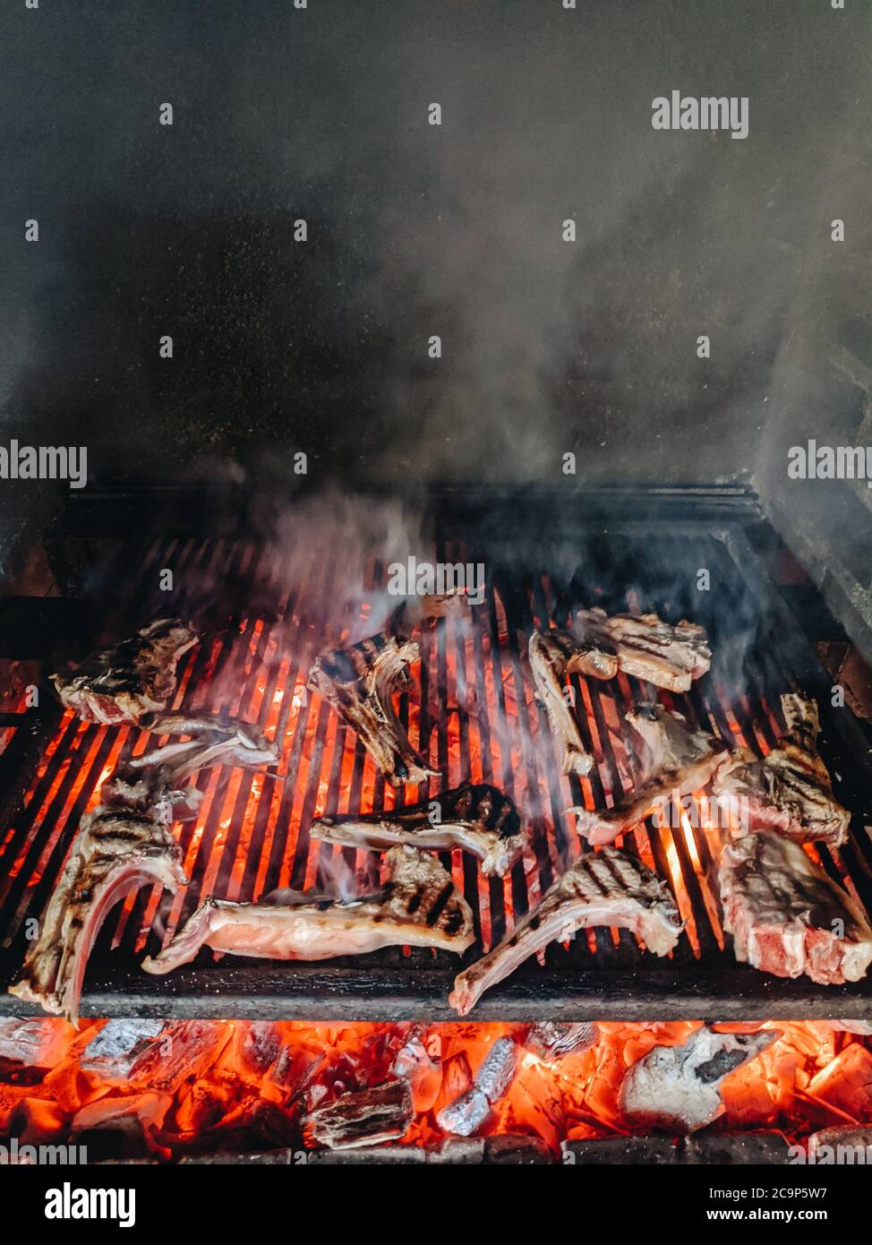 Grilled lamb ribs. Large metal grate with hot coals Stock Photo Alamy