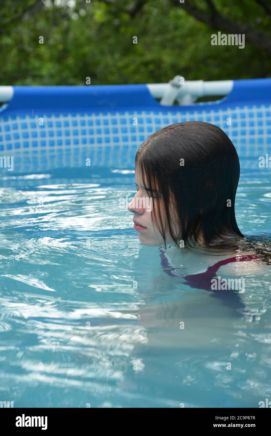 Woman relaxing by swimming pool hi-res stock photography and images - Alamy