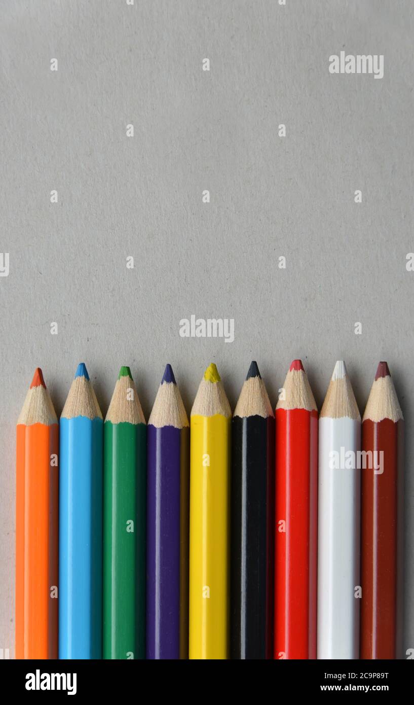 palette of colored pencils on gray cardboard Stock Photo