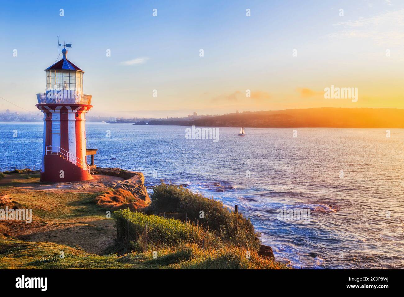 Historic Hornby lighthouse at Sydney South head facing rising sun on Pacific coast entrance to Harbour. Stock Photo