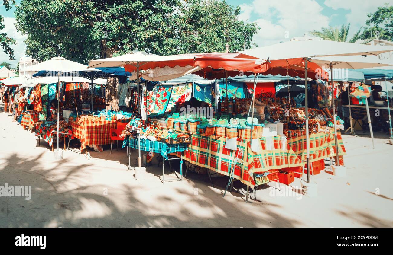 Guadeloupe, FR - February 17, 2019: Stalls in a colorful street market in Sainte Anne Stock Photo