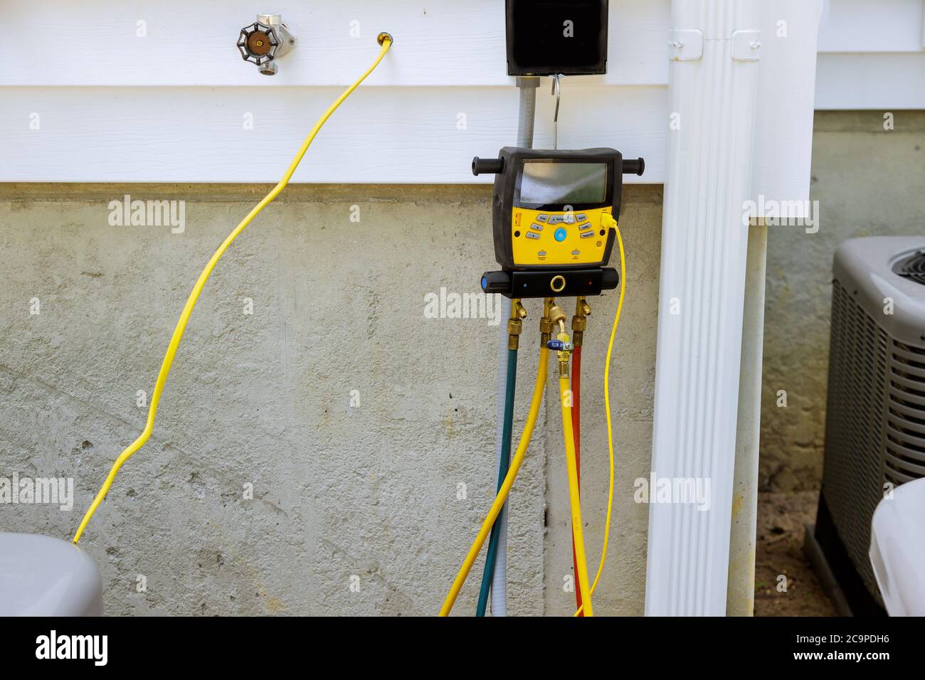 A preparing to install vacuum pump checking new air conditioner during the installation process Stock Photo