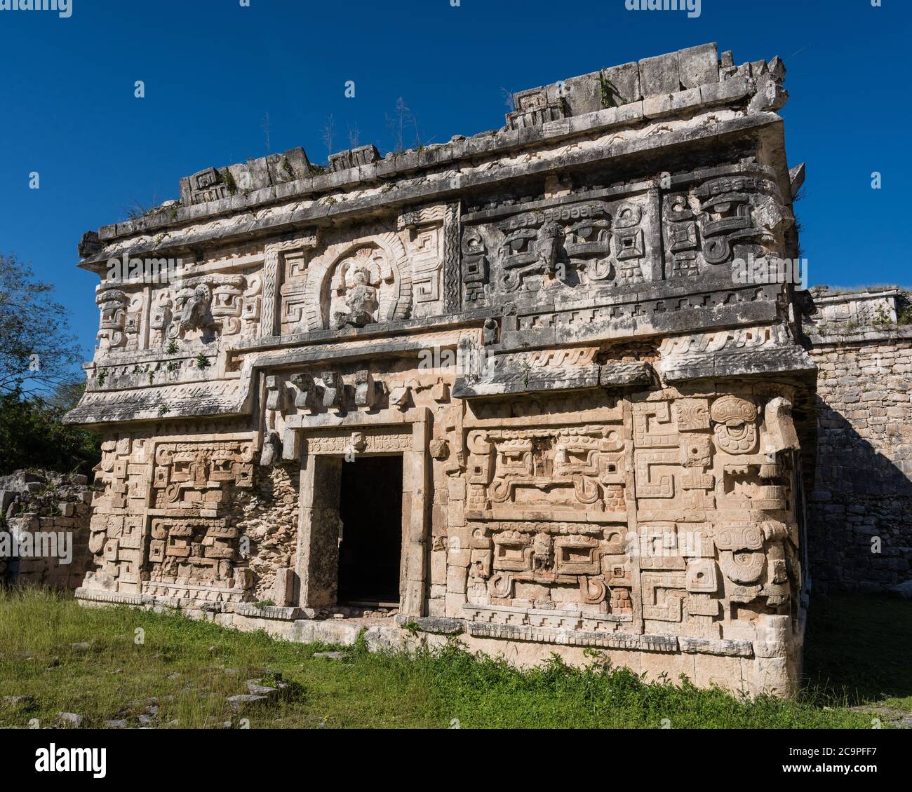 The ornately-carved Chenes-style facade of the entrance to the Nunnery Complex in the ruins of the great Mayan city of Chichen Itza, Yucatan, Mexico. Stock Photo