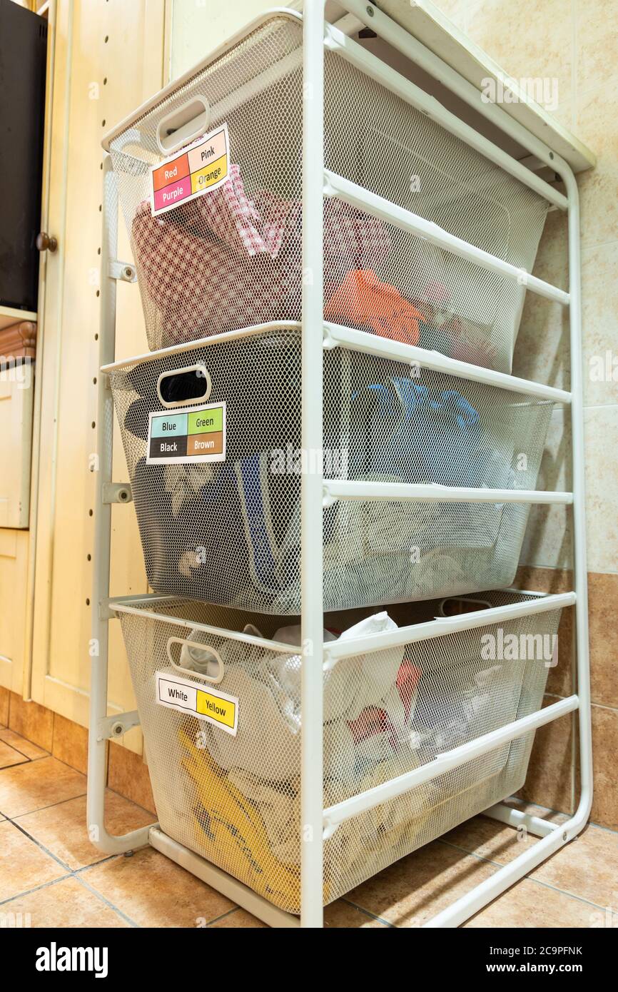 Laundry for washing sorted in group of fabric colors in basket rack Stock  Photo - Alamy