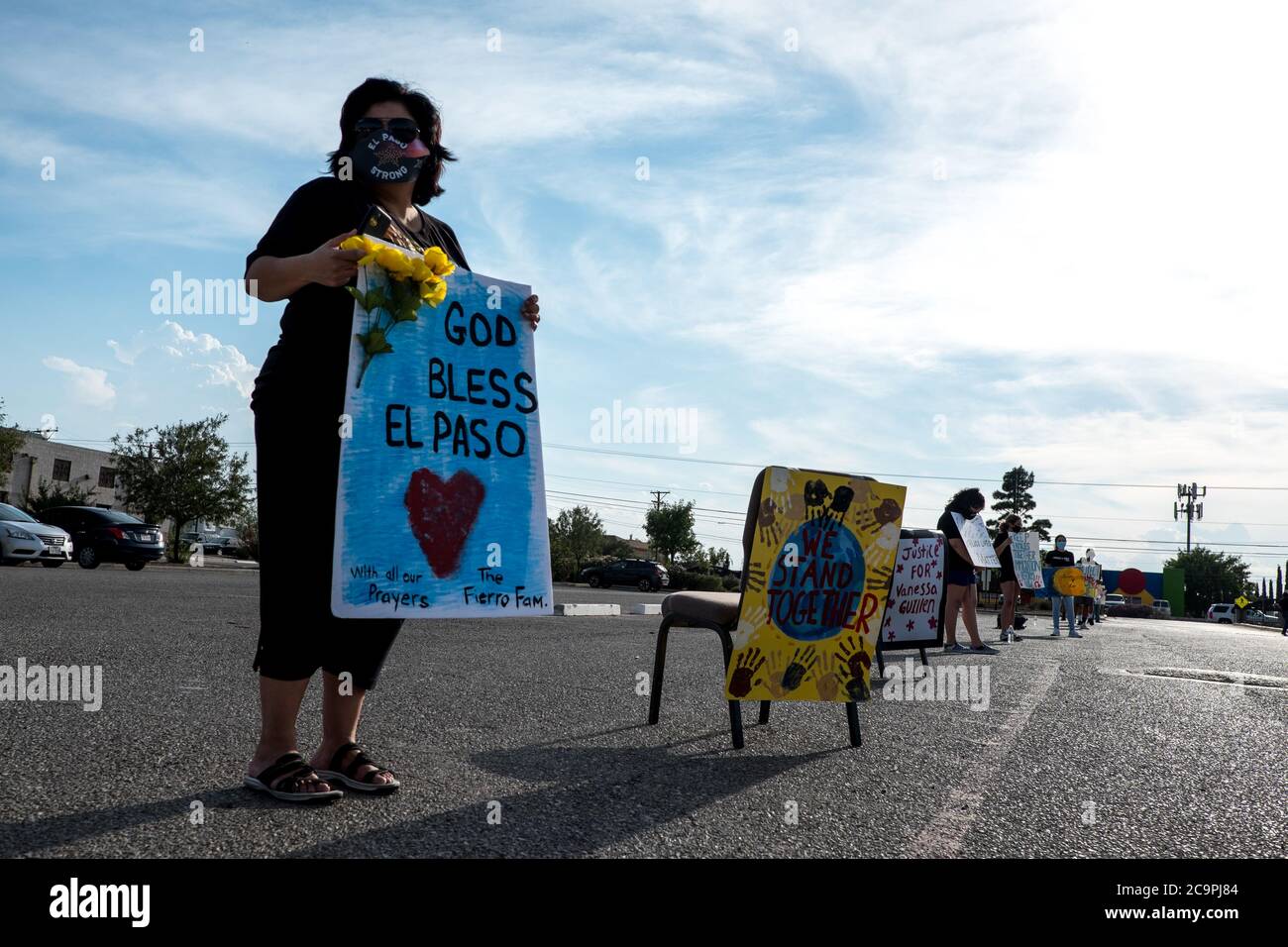 El Paso, Texas, USA. 1st Aug, 2020. ANNA PEREZ, 53, of El Paso, holds a sign as she attends a drive-thru vigil, honoring the 23 victims of the August 3 shooting, at St. Mark's Catholic Church in El Paso, Texas. Credit: Joel Angel Juarez/ZUMA Wire/Alamy Live News Stock Photo