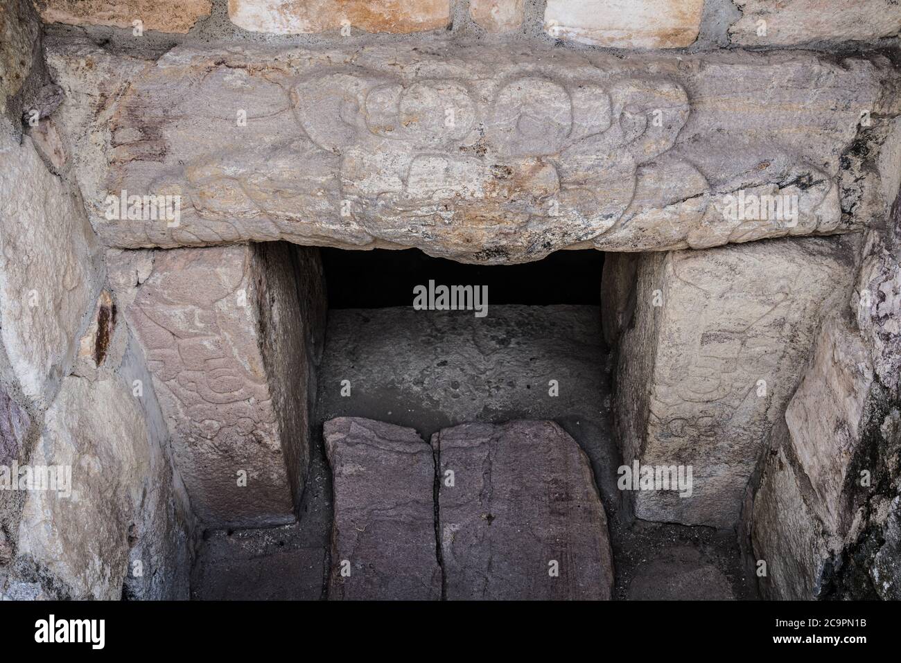 The carved stone jaguar over the entrance to Tomb 7 in the ruins of the ...