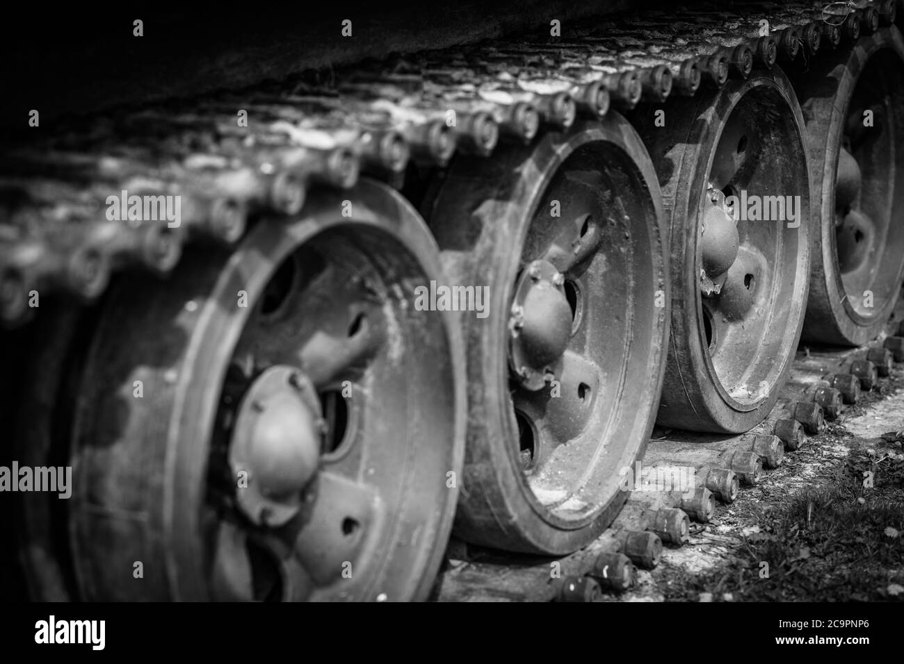 Detail shot with old tank tracks and wheels. Heavier armament tracked armored vehicles close-up. Stock Photo