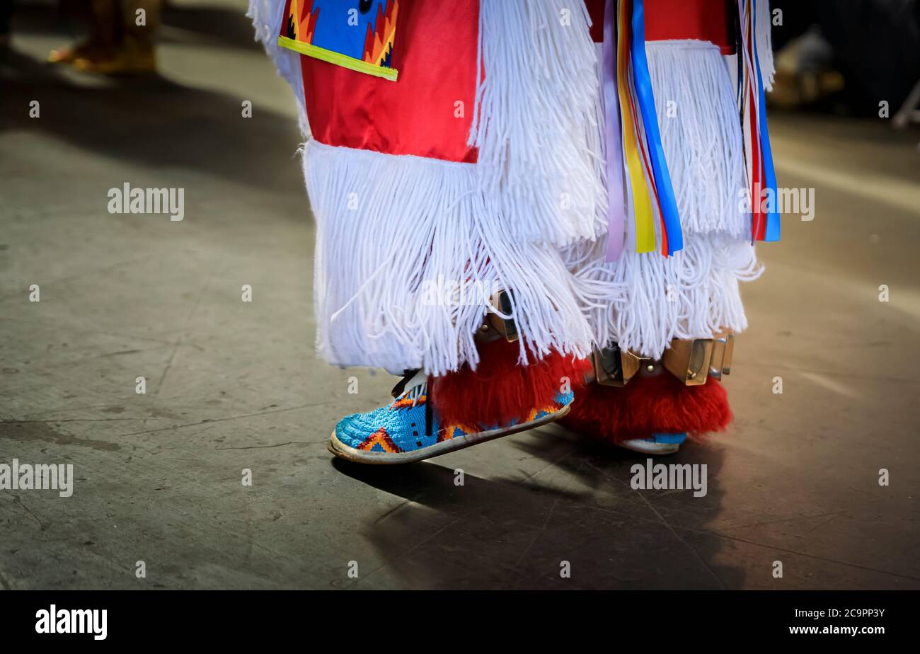 San Francisco, USA - February 08, 2020: Native American Indian dancers in handmade beaded leather moccasins decorated with jingle bells at a powwow Stock Photo