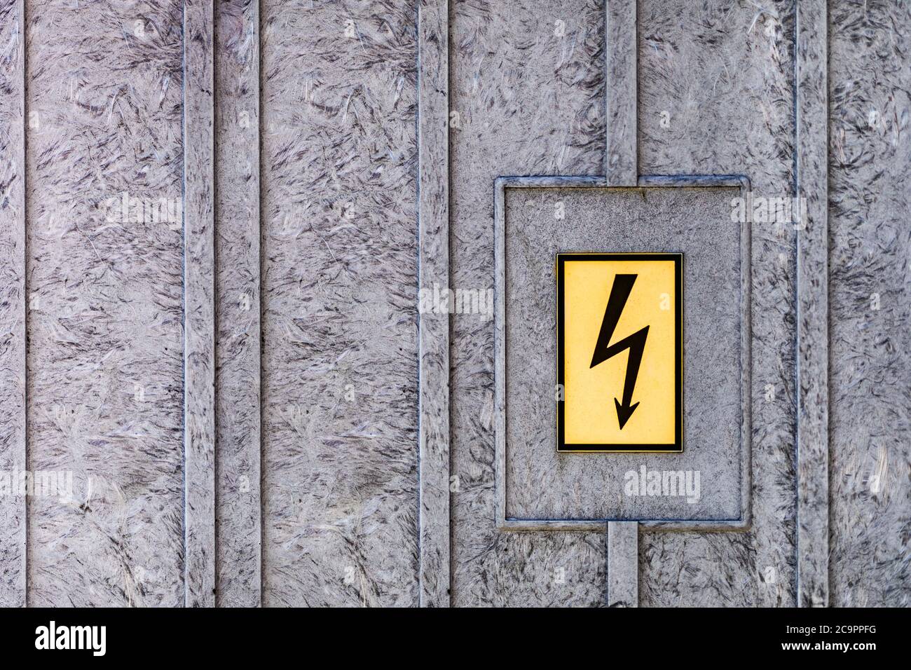 Symbol of high voltage on a steel background. Danger of electricity