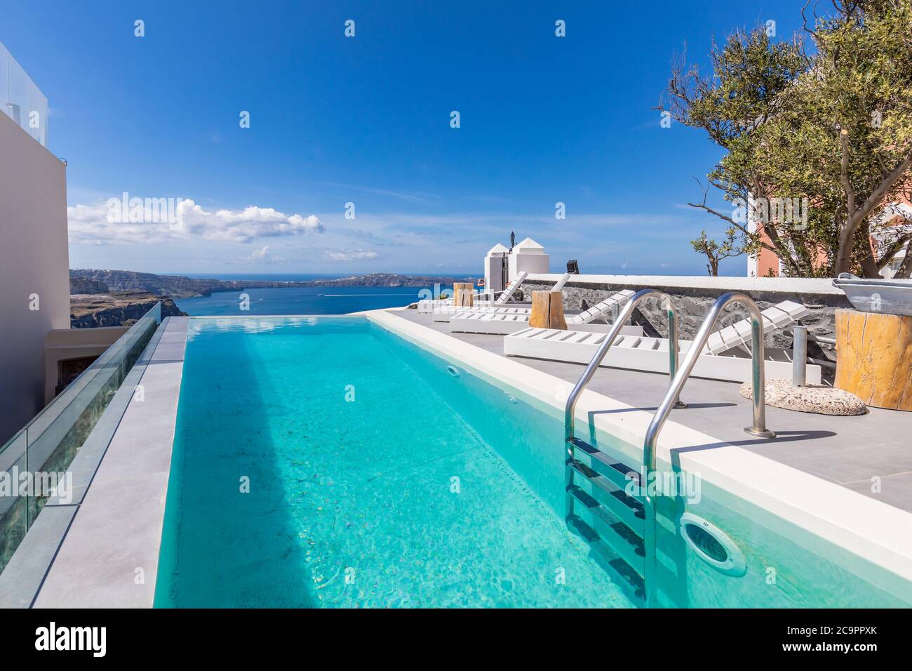 White architecture on Santorini island, Greece. Luxury infinity pool with sea view. Summer romantic wedding honeymoon destination. Couple retreat Stock Photo