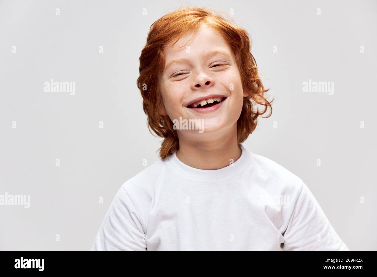 Cheerful boy red hair freckles on his face after outline of demon joy  Stock Photo