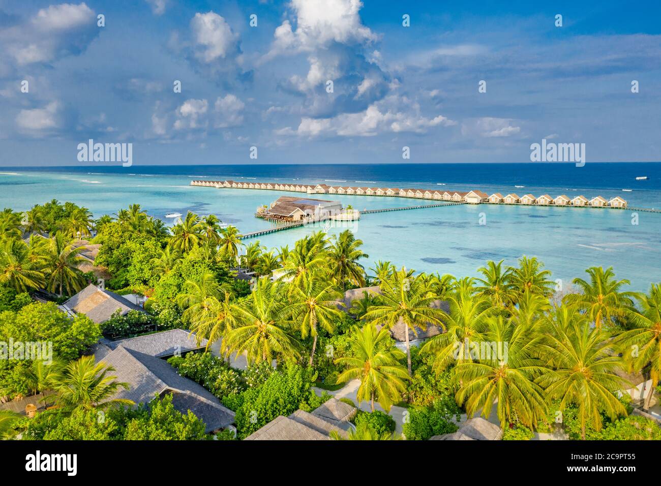 Aerial landscape, luxury tropical resort or hotel with water villas and beautiful beach scenery. Amazing bird eyes view in Maldives landscape seascape Stock Photo