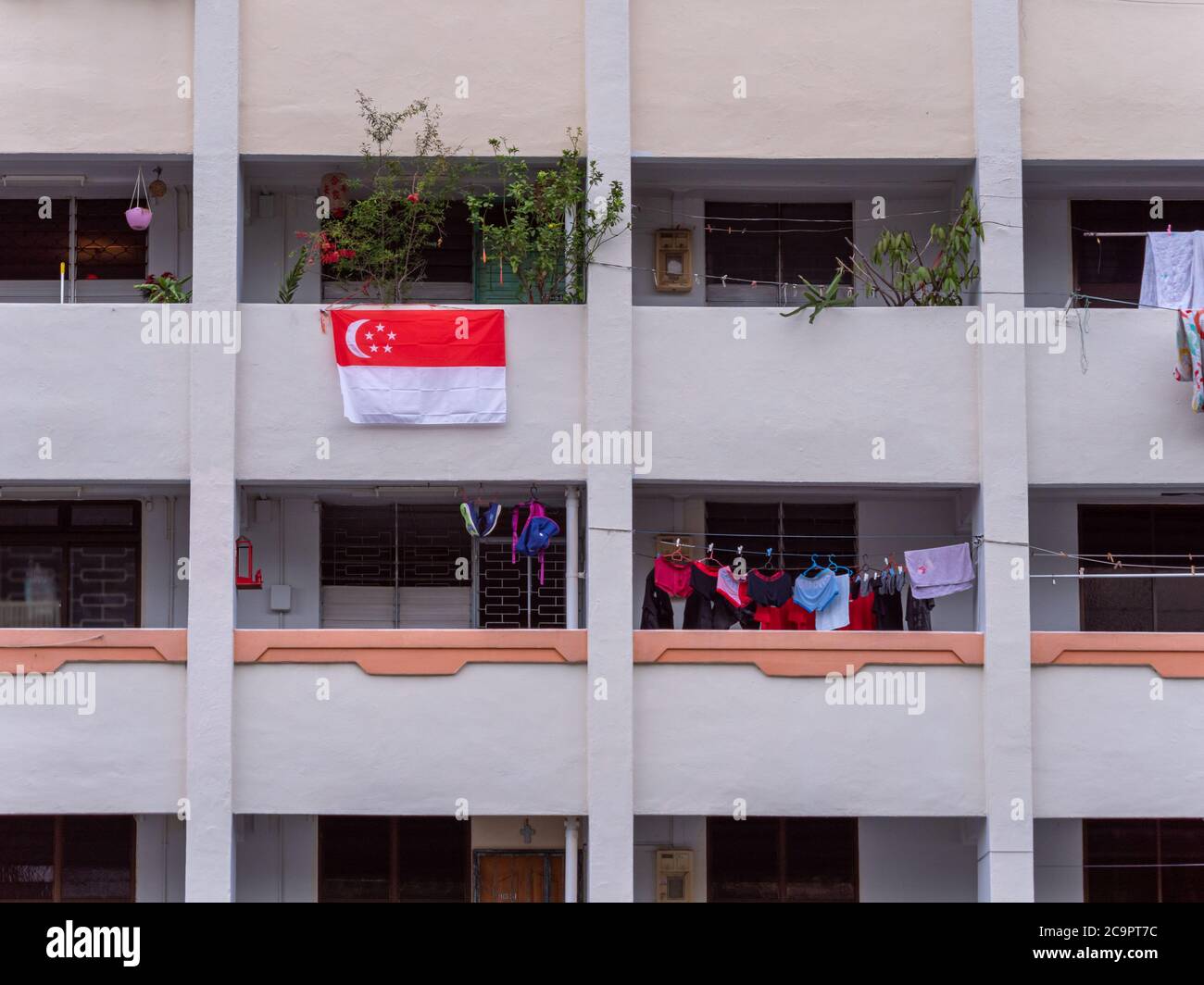 SINGAPORE – JUL 31, 2020 – A single lone Singapore national flag hung outside a flat at Sin Ming HDB residential estate in preparation for National Da Stock Photo