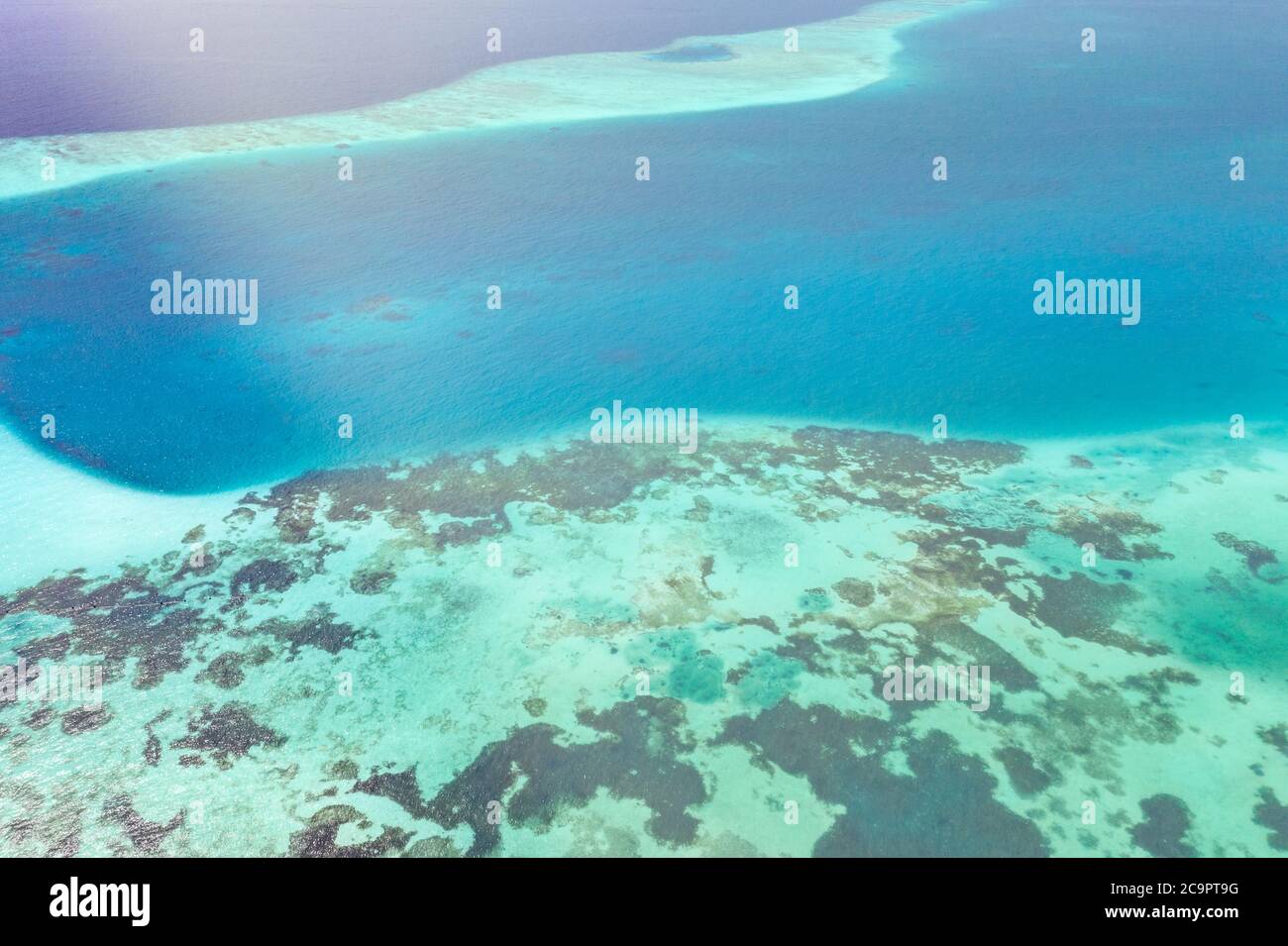 Tropical island aerial. Coral reef with turquoise lagoon. Great Barrier Reef Stock Photo