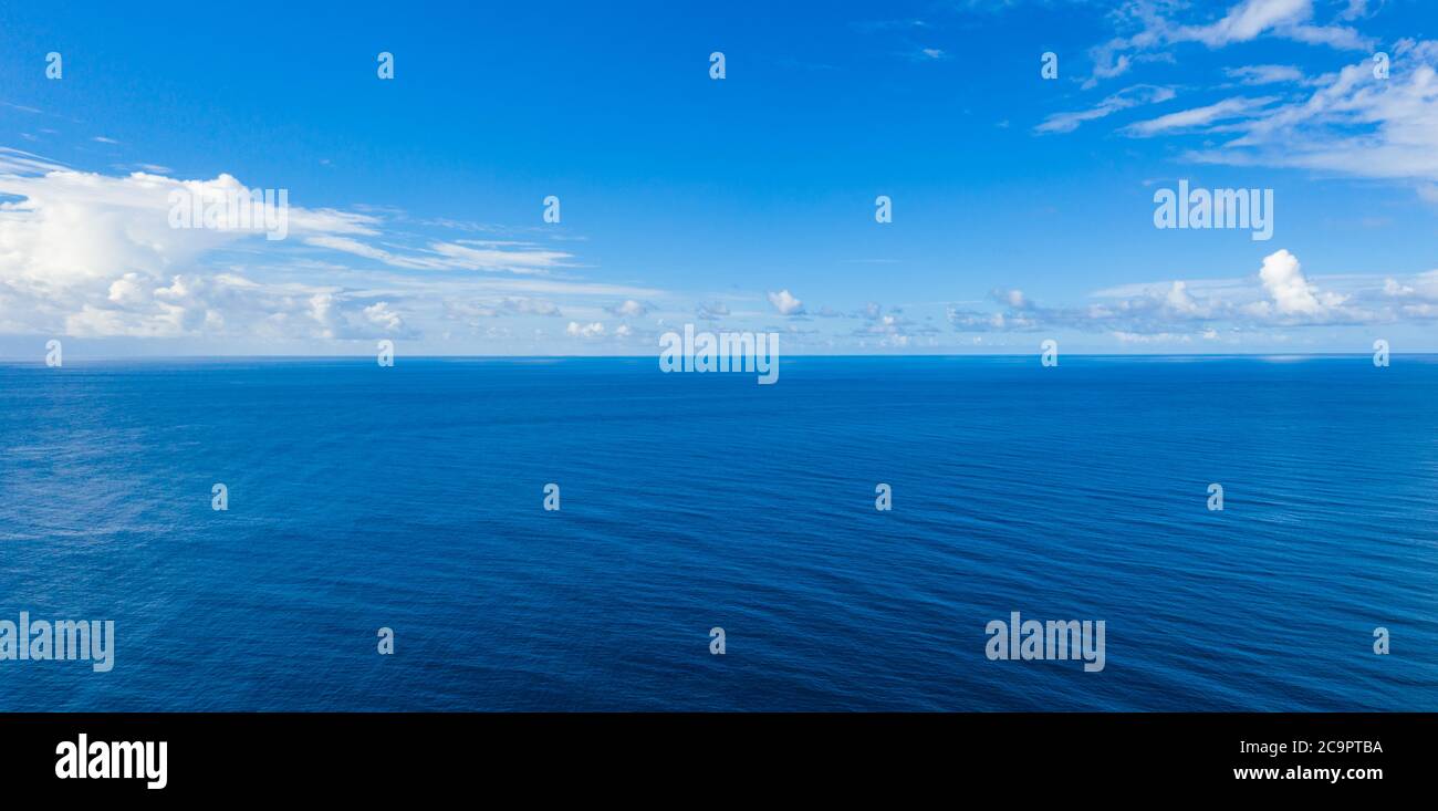 Seascape with sea horizon and almost clear deep blue sky background. Perfect sky and water, endless ocean view, blue color. Soft waves, surf concept Stock Photo