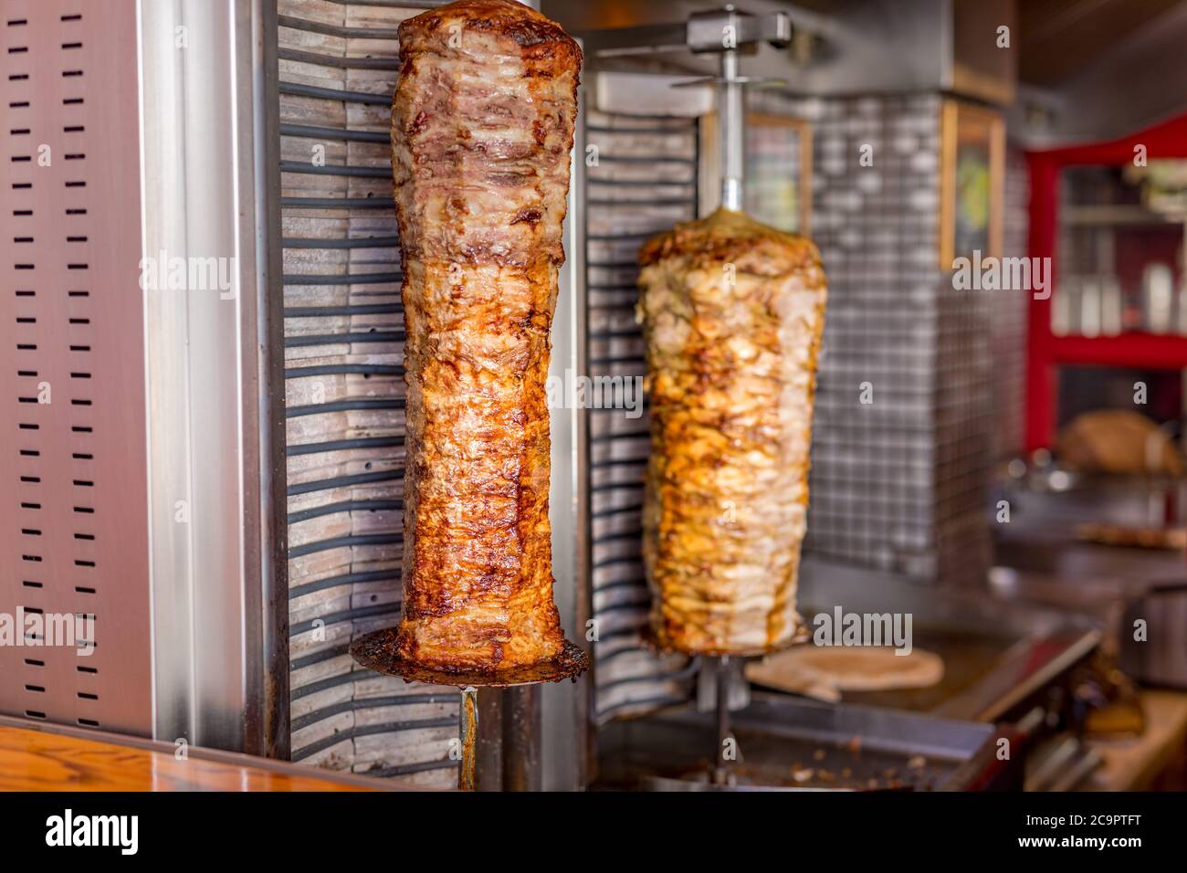 Authentic turkish doner kebab rolling outside of a restaurant on the streets of Santorini, Grecee Stock Photo