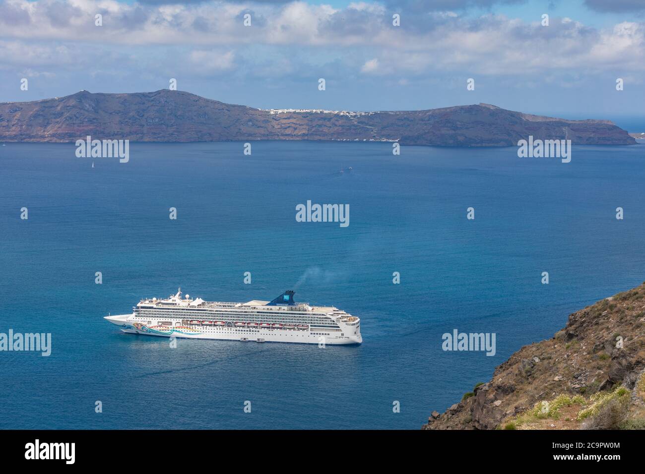 10.05.19. - Santorini, Greece: Norwegian Jade cruise ship in Santorini sea bay, Blue water with volcanic cliffs over the horizon. Luxury cruiser Fira Stock Photo