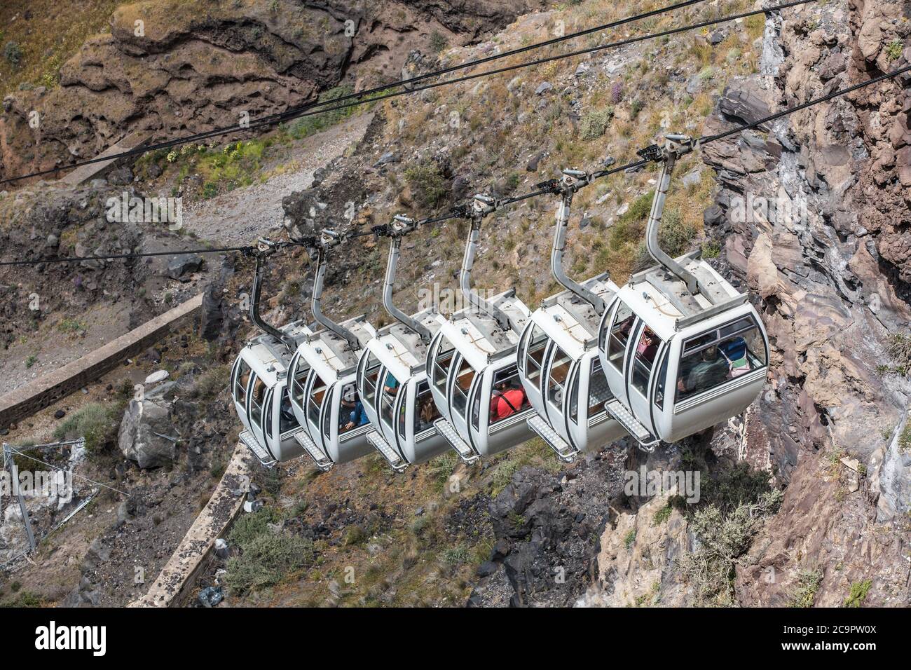 Santorini cable car, transporting tourist above the cliffs to Fira port. Summer vacation Stock Photo