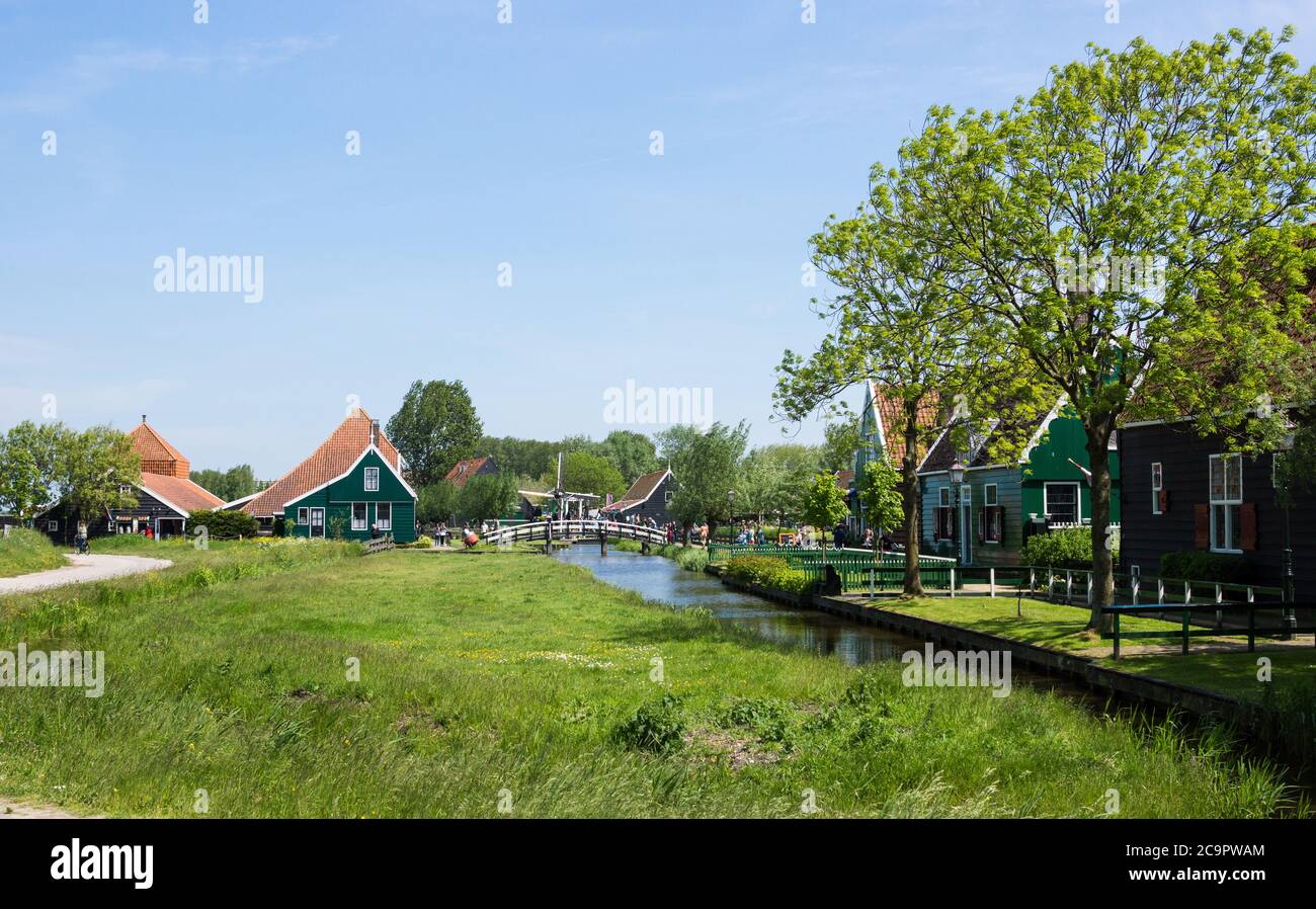 Tourists visiting the beautiful traditional houses and fields of Zaanse Schans at Zaandam near Amsterdam in the Netherlands Stock Photo
