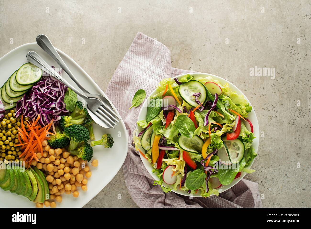 Healthy vegan lunch bowls. Vegetable salads with fresh and cooked mixed vegetables. Stock Photo
