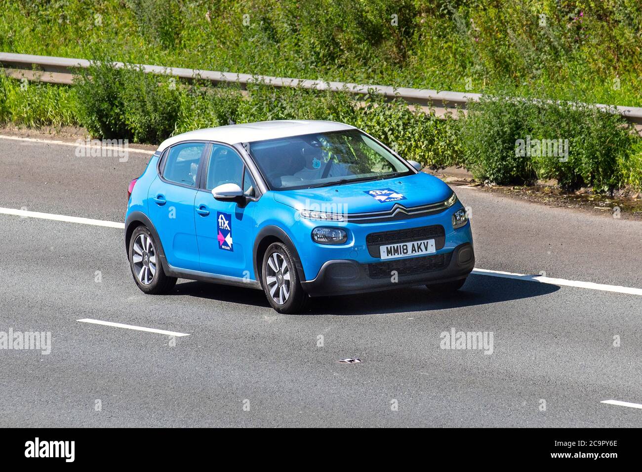 FIX AUTO Wigan 2019 blue Citroën C3 Feel Puretech; Vehicular traffic moving vehicles, cars driving vehicle on UK roads, french motors, motoring on the M6 motorway highway network. Stock Photo