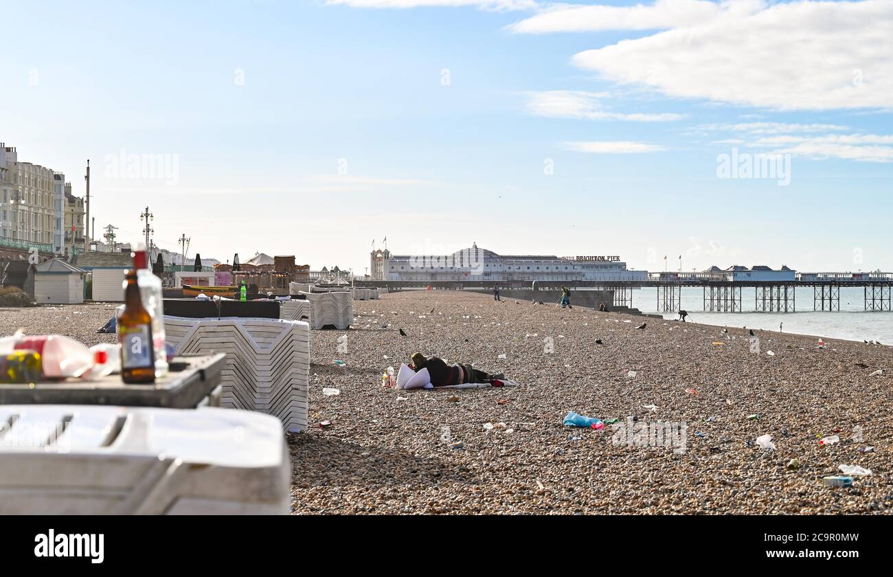 Brighton UK 2nd August 2020 - Rubbish and litter left behind on Brighton beach overnight during another hot weekend when thousands of people descended on the seaside city  : Credit Simon Dack / Alamy Live News Stock Photo