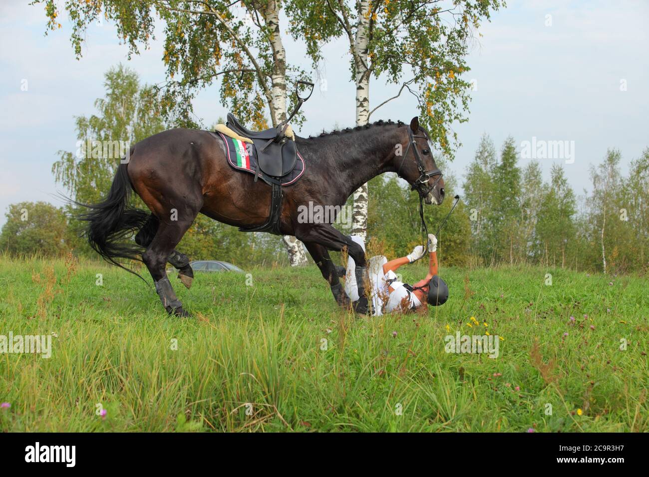 Accident at the jump - competitor falling from her horse in the cross country event Stock Photo